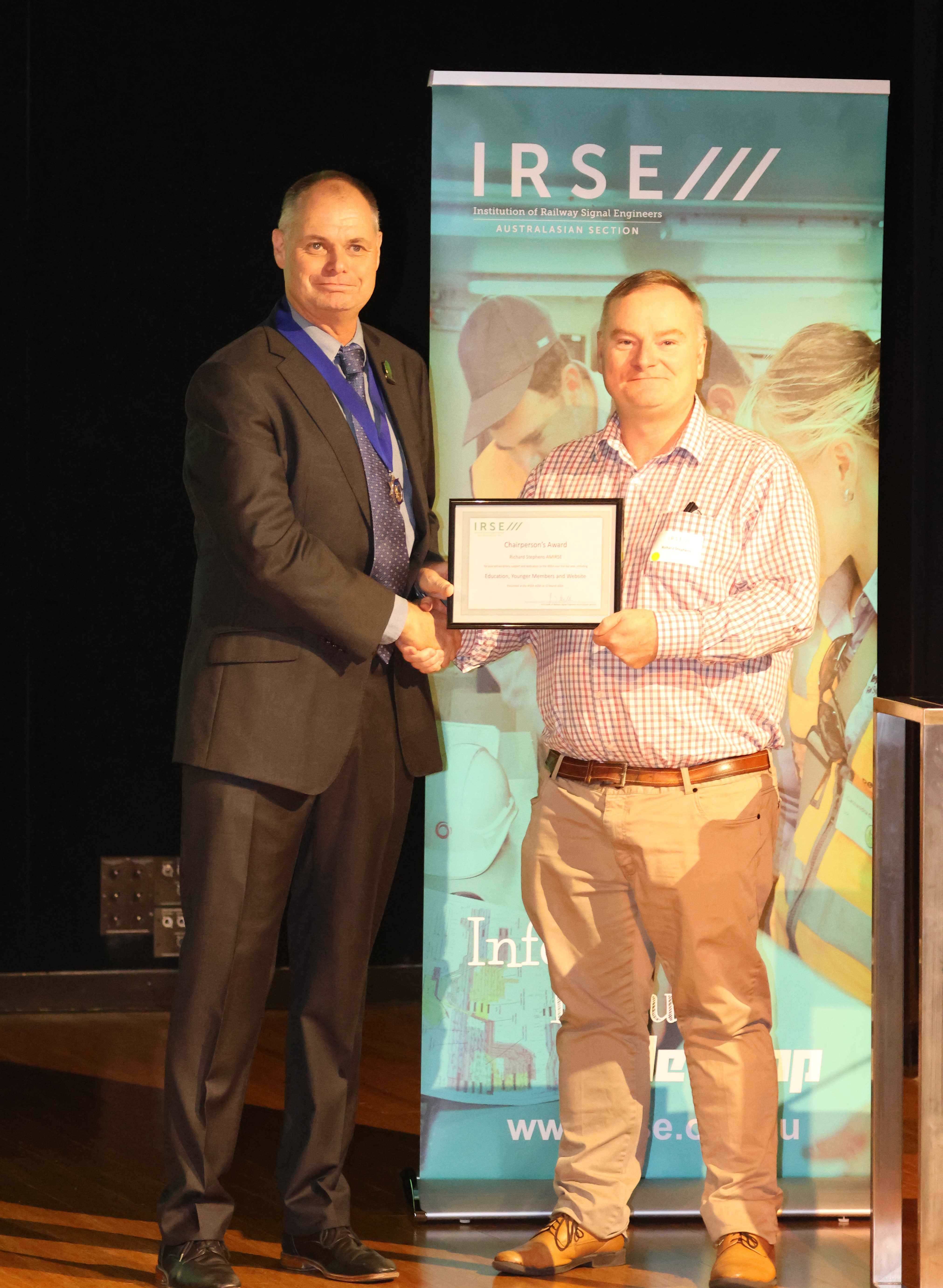 John Skilton (L) presents the 2024 Chairperson's Award to Richard Stephens